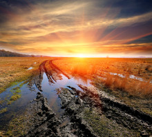 Dirt Road In Steppe On Sunset Background
