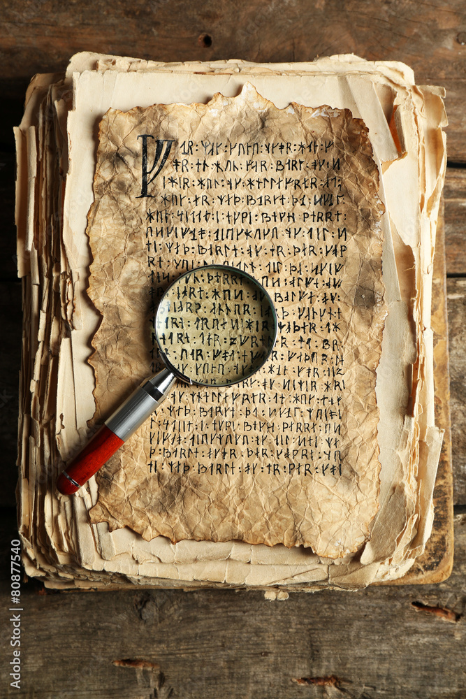 Grunge papers with hieroglyphics with magnifier