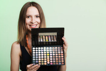 Wall Mural - Woman holds makeup professional colorful palette