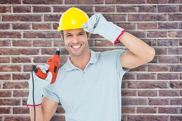 Poster - Composite image of handsome architect holding drill machine