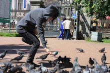 Girl Walks With Pigeon In St. Peterburg's Park