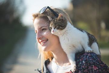 Blonde woman playing with her adorable cat