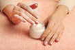© Africa Studio - Female hands with jar of cream on fabric background