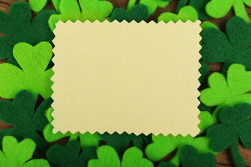 Wall Mural - Greeting card for Saint Patrick's Day with shamrocks and wooden table background