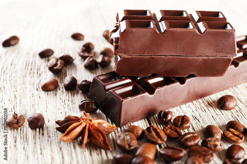 Stuffed chocolate with coffee beans on wooden table, closeup