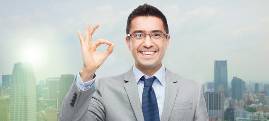 Canvas Print - happy smiling businessman in eyeglasses and suit