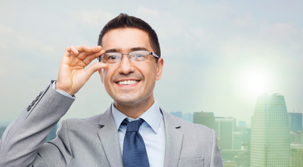 happy smiling businessman in eyeglasses and suit