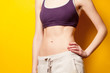 © Masson - Woman showing her abs after weight loss