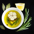 bowl with olive oil, garlic, ppeppercorn  and rosemary, top view