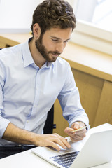 Wall Mural - Man paying shopping online withe credit card on computer