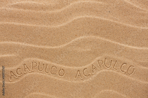Fotografija Acapulco inscription on the wavy sand