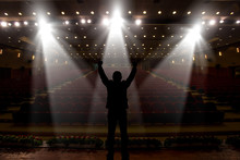 Silhouette Of Actors In The Spotlight