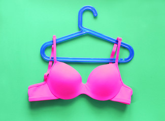 Summer concept, bra on coat hanger on green. (Pop art style)