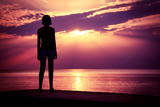 Fototapeta Na sufit - Silhouette of Young Woman Watching Sea Sunset