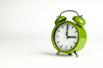 Three o'clock. Green classic clock on white background.