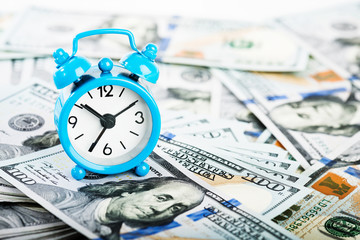 Wall Mural - Time is money. Alarm clock and dollar banknotes.