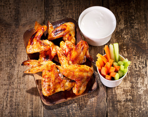 Wall Mural - chicken wings with fresh vegetables and sauce