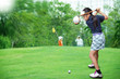 Little asian girl playing golf