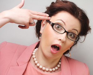 Young businesswoman in pink wearing glasses.