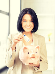 Canvas Print - lovely woman with piggy bank and money