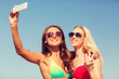 © Syda Productions - two smiling women making selfie on beach