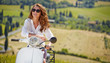 © ZoomTeam - Young beautiful italian woman sitting on a italian scooter in It