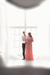 © Kyrylo Ryzhov - Silhouette photo of pregnant couple embracing against big window