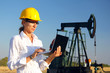 © branex - Female engineer in an oilfield working with notebook
