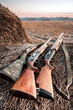 Hunting shotguns on haystack, soft focus on shutgun butt