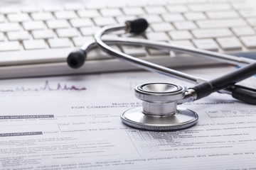 Poster - Clinic. Stethoscope with financial on the desk.