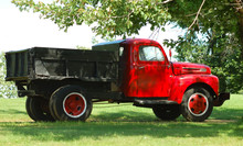 Old Red Truck On The Grass