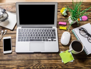 Sticker - View. Mix of office supplies and gadgets on a wooden desk