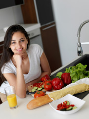 Canvas Print - Young Woman Cooking in the kitchen