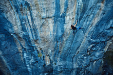 Rock Climber Climbing Up A Cliff
