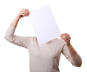 Woman covering her face with blank sheet of paper isolated on white