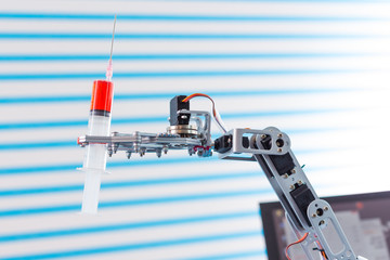 Canvas Print - medical syringe in robot arm