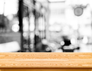Poster - Empty wood table top with coffee shop blur with bokeh background