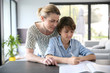 © goodluz - Mother helping kid with homework