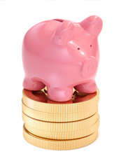 Small piggy bank on top of golden coins. Money and business conc