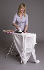 Wall Mural - Woman ironing a shirt