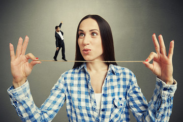 Wall Mural - amazed woman looking at small man