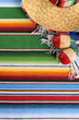 Mexican background serape striped blanket with sombrero maracas Mexico cinco de mayo festival vacation photo vertical
