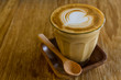 © amnach - Cappuccino or latte coffee on wooden table.