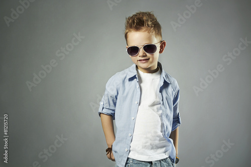 Naklejka na drzwi fashionable little boy in sunglasses.stylish child in jeans