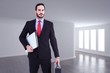 © WavebreakMediaMicro - handsome businessman holding briefcase and laptop