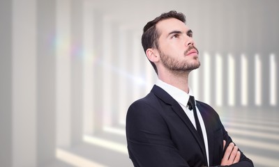 Poster - Composite image of thinking businessman with his arms crossed