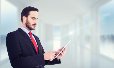 Poster - Composite image of businessman scrolling on his digital tablet