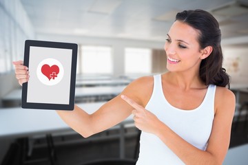Poster - Composite image of pretty brunette using tablet pc