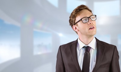 Poster - Composite image of young businessman thinking and looking up