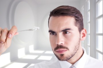 Poster - Composite image of focused businessman holding white cable